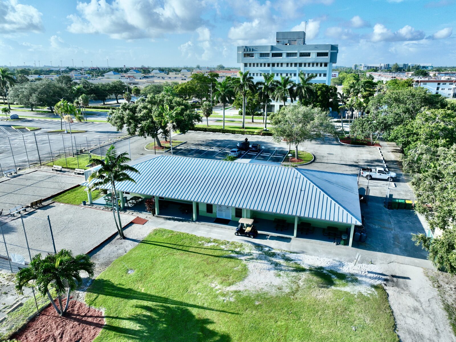 Pavillion and parking lot aerial view in front of tall building