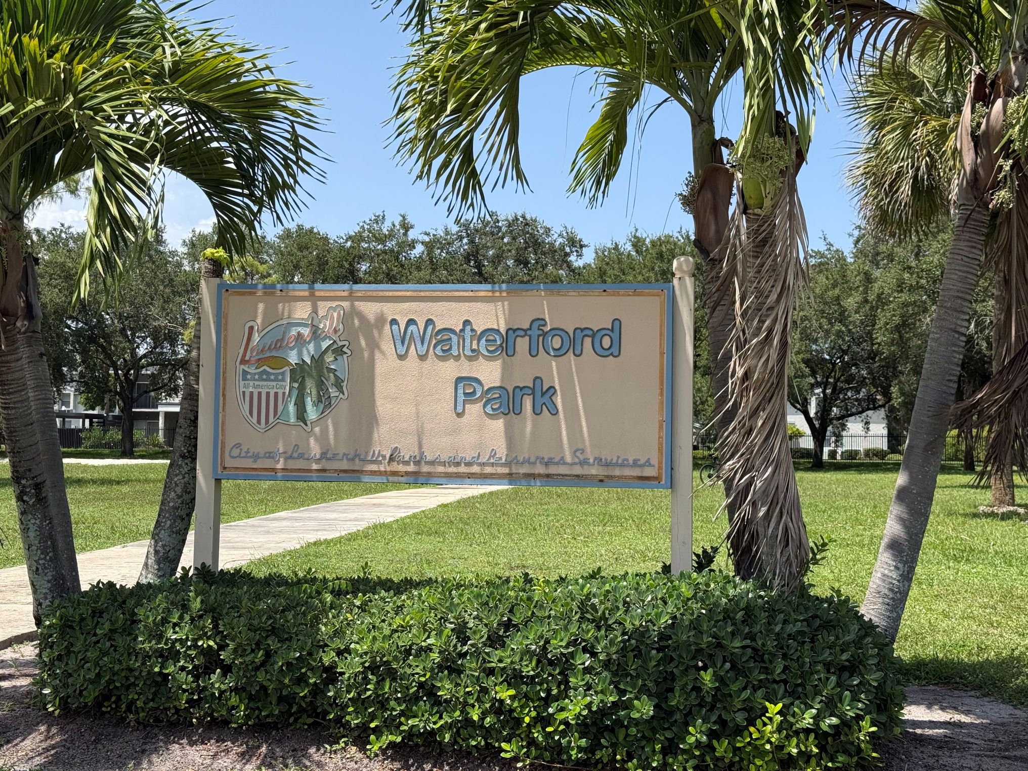 Waterford Park sign between two palm trees